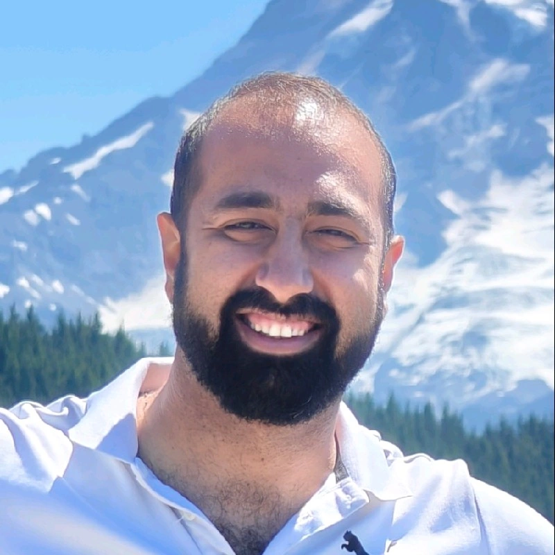 Tapan Chugh outdoors in front of snow-covered mountains